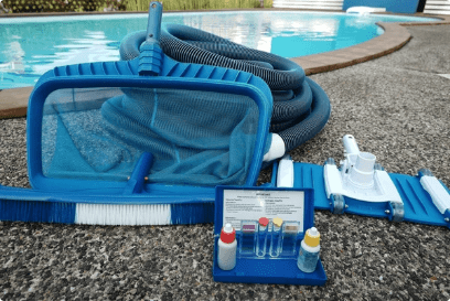 Image of pool cleaning supplies with kit beside pool