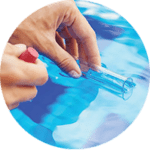Image of hands holding pool chemical treatment beaker